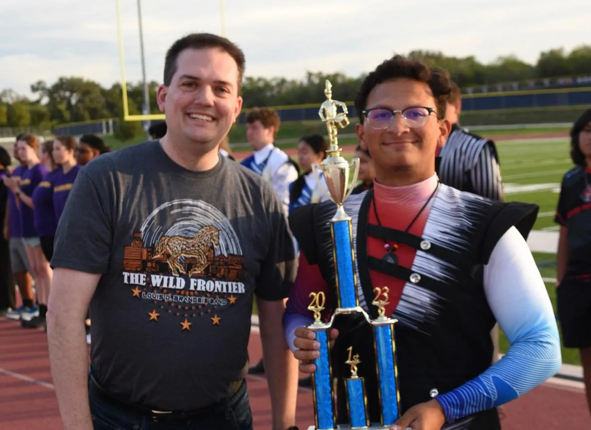 Dr. Hulme and a patient pose with a sports tropy.