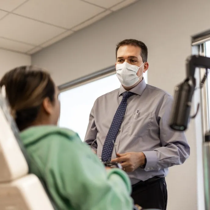 Dr. Hulme talks to a patient at our China Grove practice.